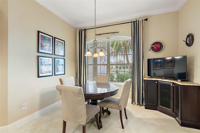 dining area with ornamental molding, a notable chandelier, and baseboards