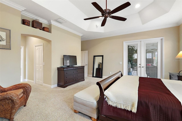 bedroom with light carpet, visible vents, a raised ceiling, access to exterior, and french doors