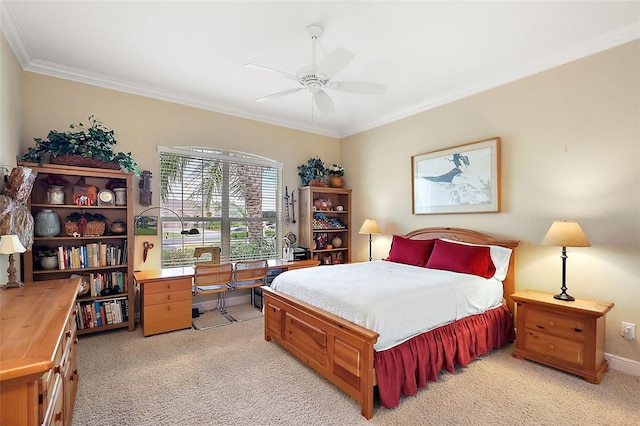 bedroom featuring crown molding, baseboards, a ceiling fan, and light colored carpet