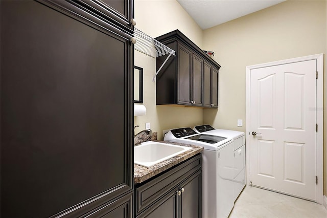 clothes washing area featuring washer and dryer, cabinet space, a sink, and light tile patterned floors