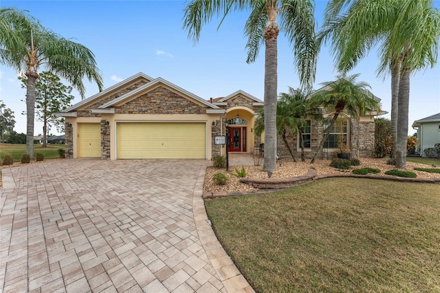 view of front of house with a garage and a front lawn