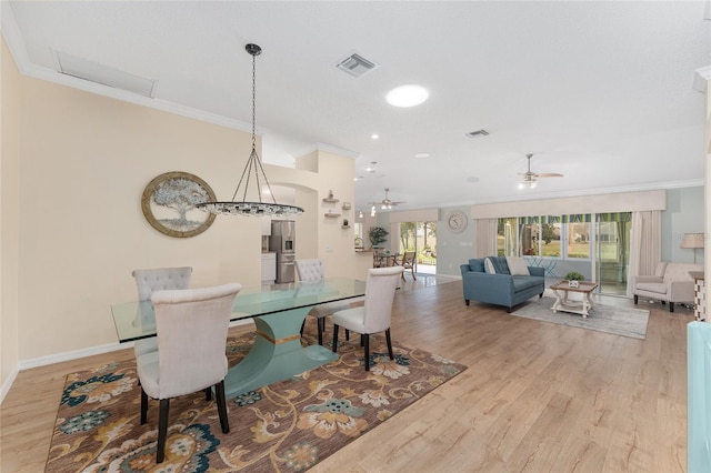 dining room featuring crown molding, ceiling fan, and light hardwood / wood-style floors