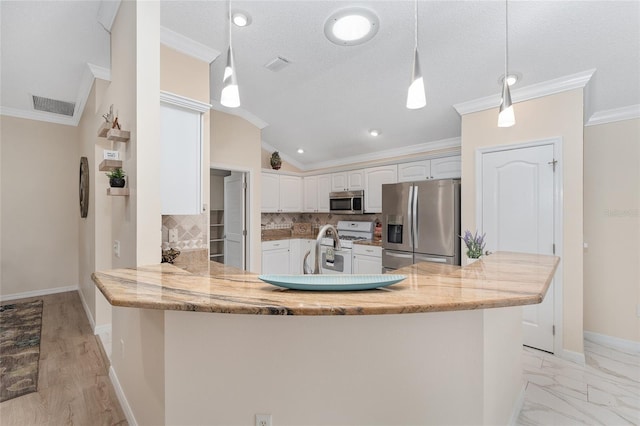 kitchen featuring white cabinetry, hanging light fixtures, stainless steel appliances, light stone countertops, and kitchen peninsula