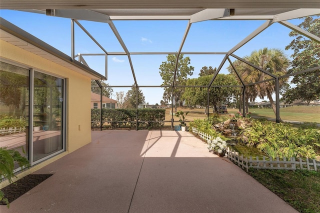 view of patio featuring glass enclosure