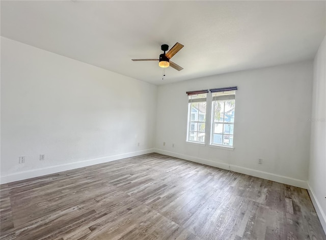 unfurnished room with hardwood / wood-style flooring and ceiling fan