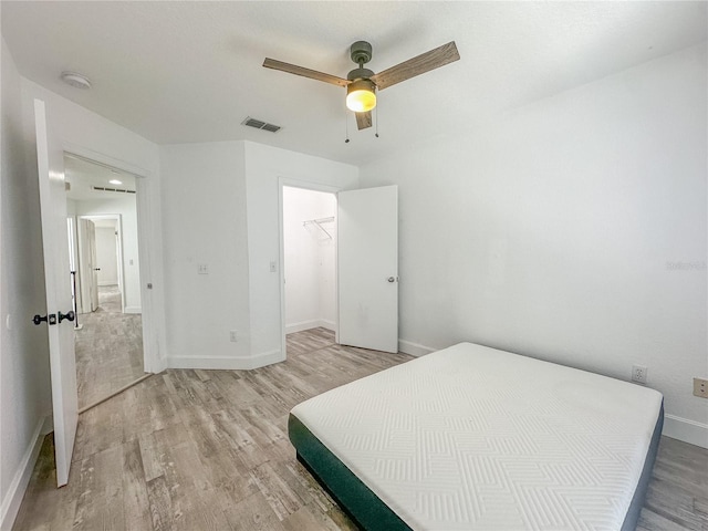 bedroom with ceiling fan and light hardwood / wood-style floors