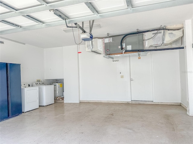 garage featuring a garage door opener, washing machine and dryer, and water heater