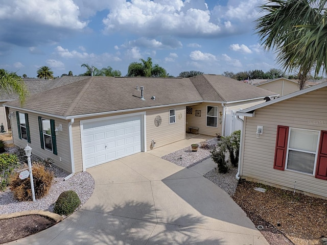 ranch-style house featuring a garage, driveway, and roof with shingles