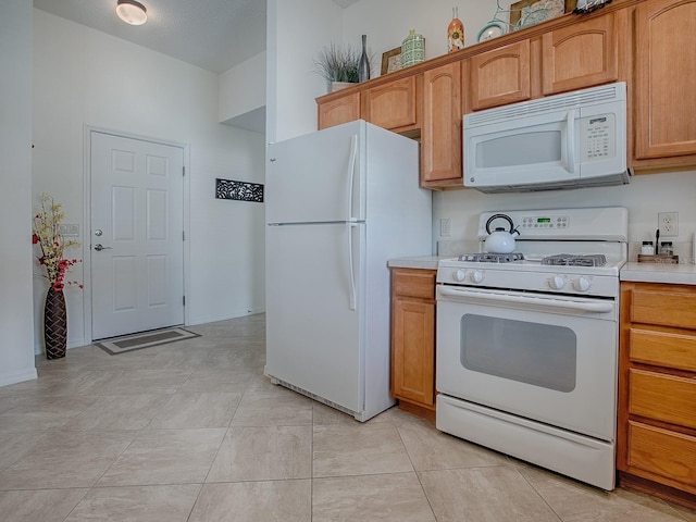 kitchen featuring white appliances and light countertops