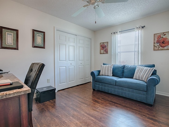 office featuring dark wood-style floors, a textured ceiling, and a ceiling fan