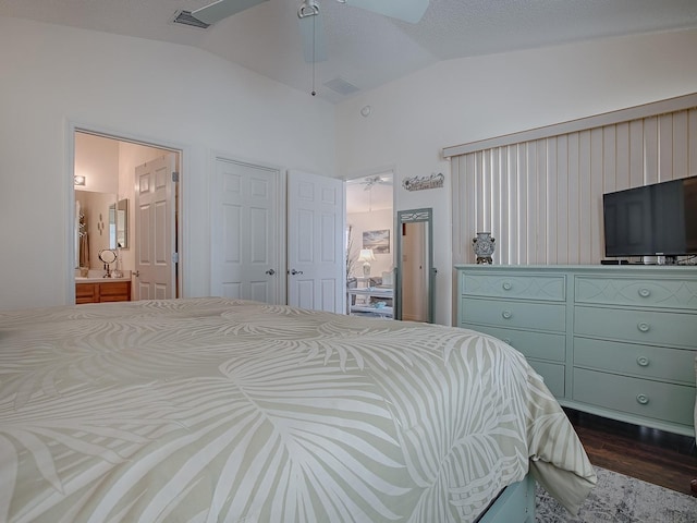 bedroom featuring visible vents, dark wood finished floors, connected bathroom, ceiling fan, and vaulted ceiling