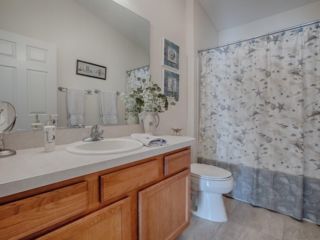 bathroom featuring toilet, tile patterned flooring, shower / bath combo with shower curtain, a textured ceiling, and vanity