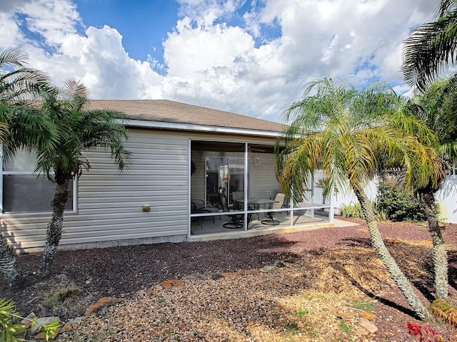 back of property featuring a sunroom and a patio