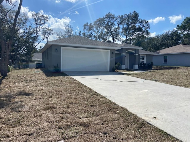 single story home with a garage and a front yard