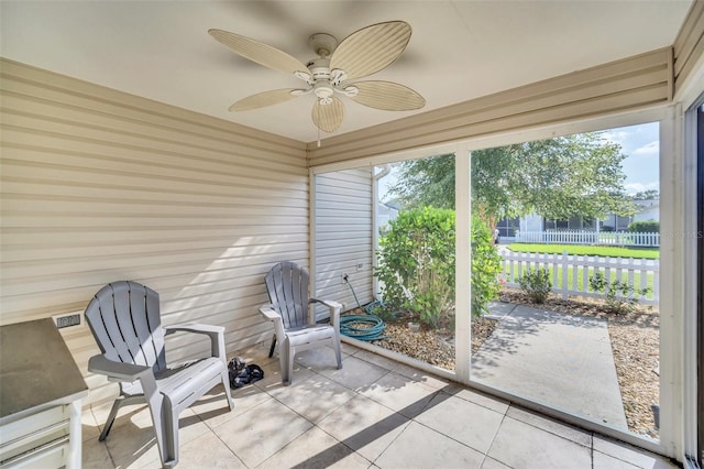 sunroom featuring a ceiling fan