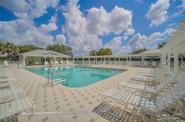 community pool featuring a patio area, fence, and a gazebo