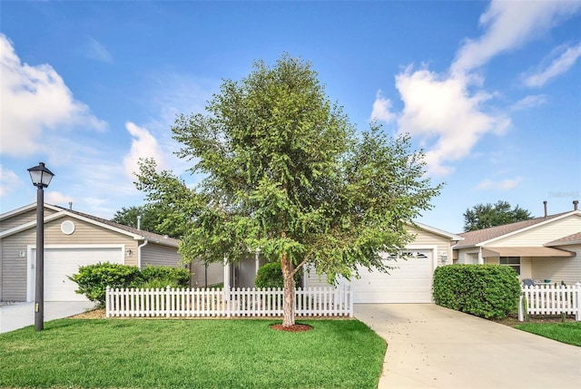 view of front of property featuring a garage, fence, a front lawn, and concrete driveway