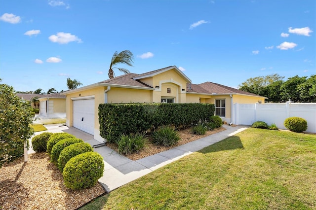 ranch-style home featuring a garage, a front yard, fence, and stucco siding