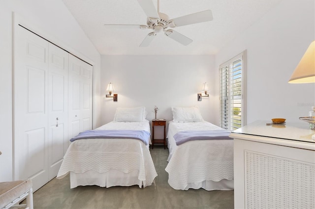 bedroom with ceiling fan, a closet, and carpet flooring