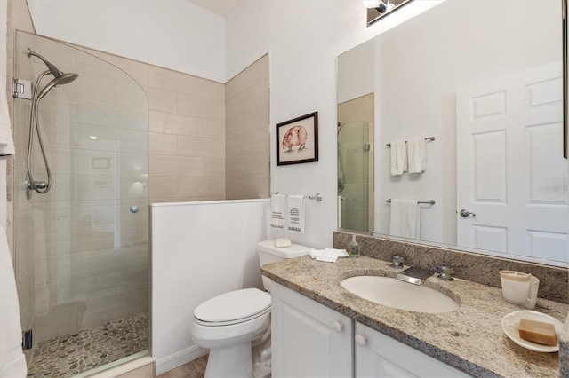 full bath with toilet, a shower stall, and vanity