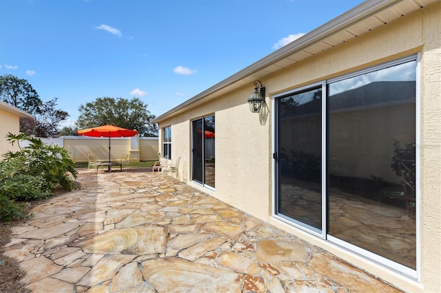 view of patio featuring fence