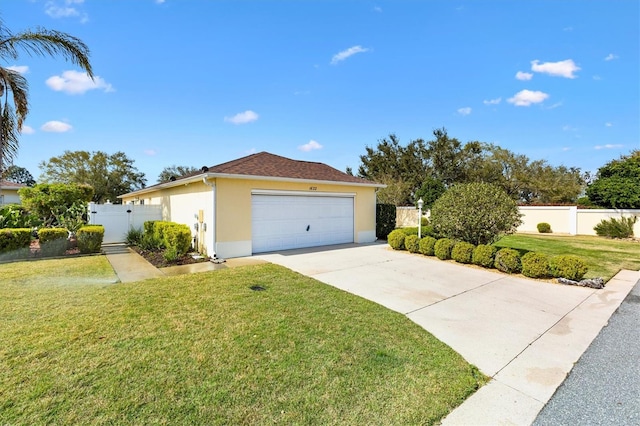 view of front of home with fence, concrete driveway, a gate, stucco siding, and a front lawn