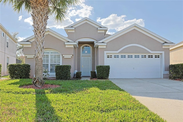 view of front of property with a garage and a front yard