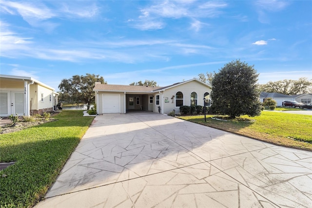 ranch-style house featuring a garage and a front lawn