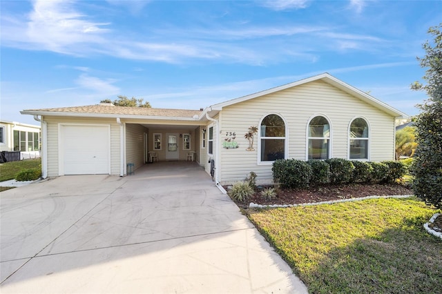 single story home featuring a carport, a garage, and a front lawn