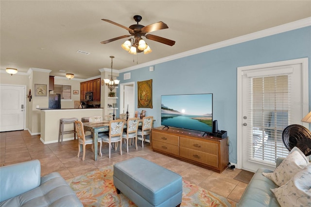 living room with ornamental molding, ceiling fan with notable chandelier, and light tile patterned flooring