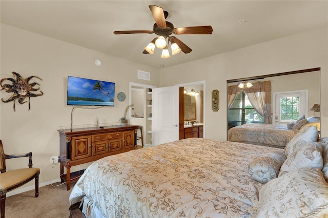 carpeted bedroom featuring ceiling fan and ensuite bathroom