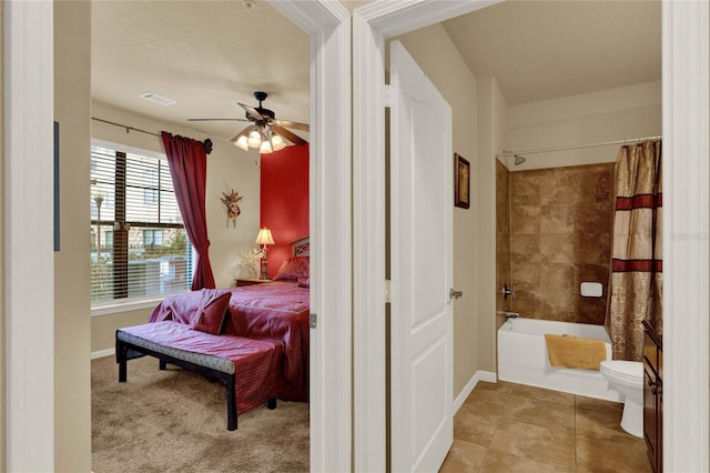 interior space with ceiling fan, tile patterned flooring, shower / bath combination with curtain, a textured ceiling, and toilet