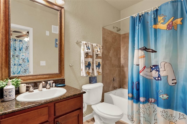 full bathroom with ceiling fan, vanity, toilet, and shower / tub combo