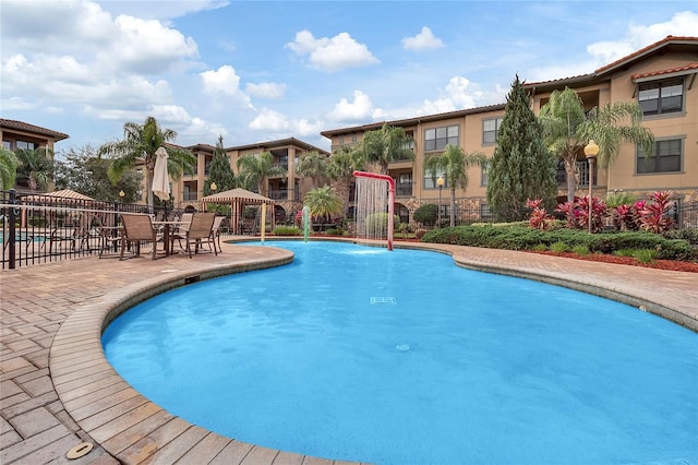 view of swimming pool with a gazebo and pool water feature