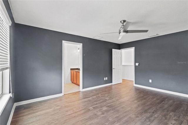 empty room with hardwood / wood-style flooring and ceiling fan