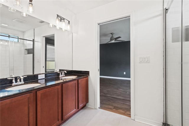 bathroom featuring vanity, ceiling fan, and a shower with shower door