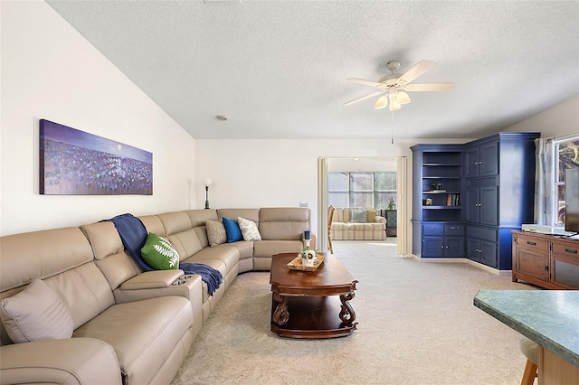 carpeted living room with a textured ceiling, lofted ceiling, and ceiling fan