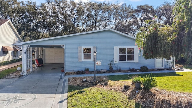 view of front facade with a front lawn, a carport, and a garage