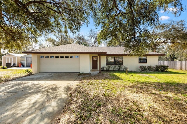 ranch-style home with a garage and a front lawn