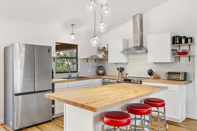 4723 Crk 306, Lake Panasoffkee, FL 33538 - kitchen with white cabinetry, wood counters, appliances with stainless steel finishes, and pendant lighting