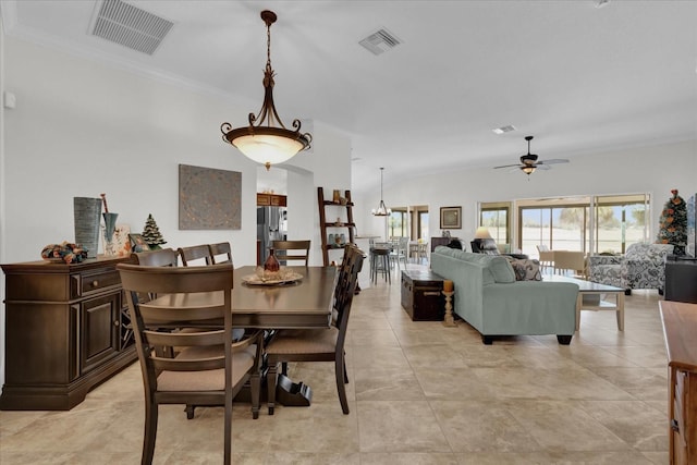 tiled dining room featuring crown molding and ceiling fan with notable chandelier