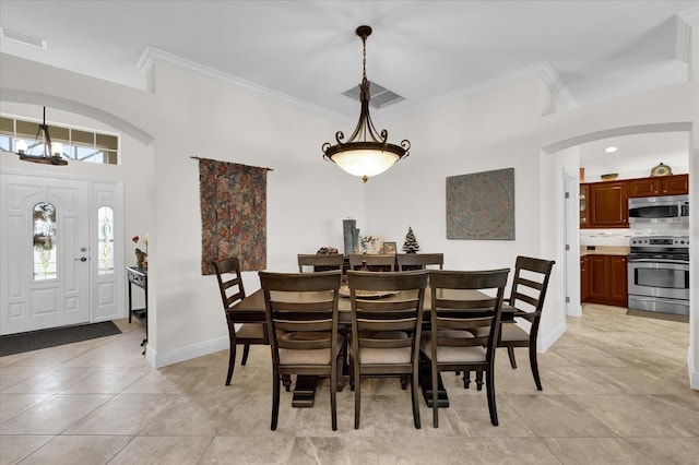 tiled dining area with plenty of natural light and ornamental molding