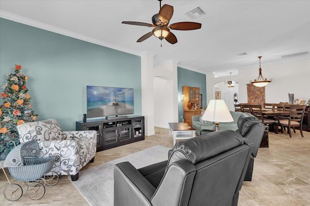 living room with ornamental molding and ceiling fan