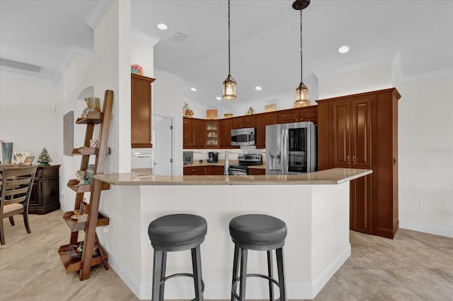 kitchen featuring appliances with stainless steel finishes, light stone counters, ornamental molding, decorative light fixtures, and kitchen peninsula