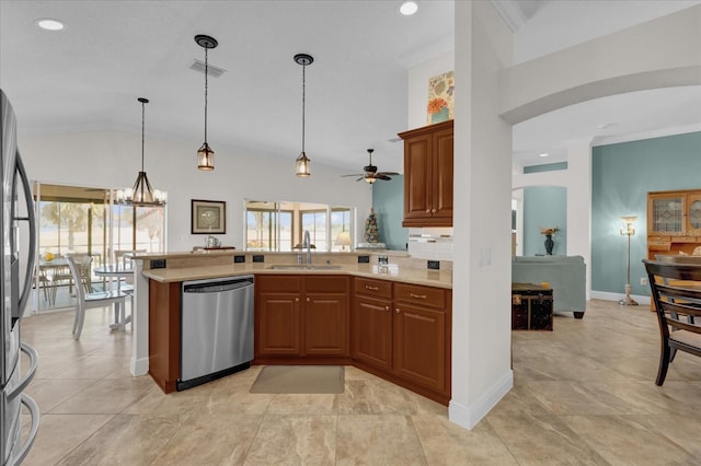 kitchen featuring lofted ceiling, sink, hanging light fixtures, stainless steel appliances, and kitchen peninsula