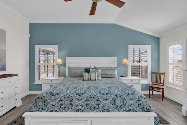 bedroom featuring lofted ceiling, light hardwood / wood-style flooring, and ornamental molding