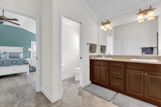 bathroom featuring ceiling fan, vanity, ornamental molding, vaulted ceiling, and toilet