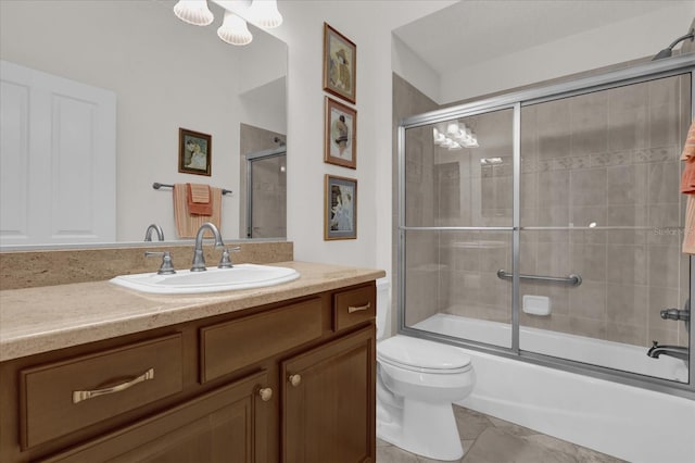 full bathroom featuring toilet, vanity, and bath / shower combo with glass door