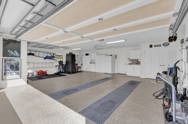 garage with white refrigerator and ceiling fan