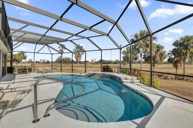 view of pool with pool water feature, a patio, and glass enclosure